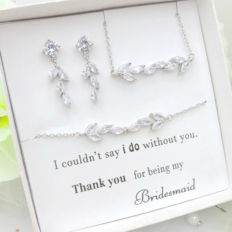 A bridesmaid gift box with clear leaf-style rhinestone earrings, necklace, and bracelet from Etsy