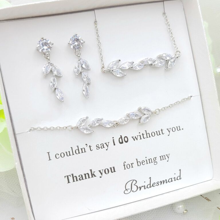 A bridesmaid gift box with clear leaf-style rhinestone earrings, necklace, and bracelet from Etsy