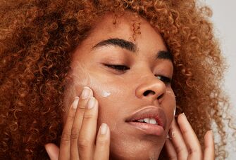 Woman applying face cream