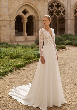 A-line wedding dress with V-neckline and long sleeves. Lace bodice, stretch crepe skirt and back opening.
