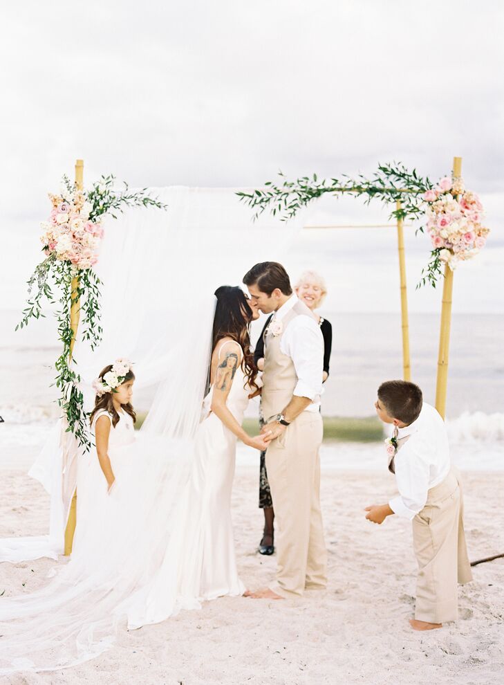 Ceremony kiss under a decorated huppah