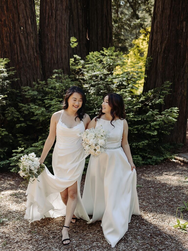 Two brides in wedding dresses in the woods