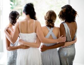 Bride and bridesmaids looking out the window