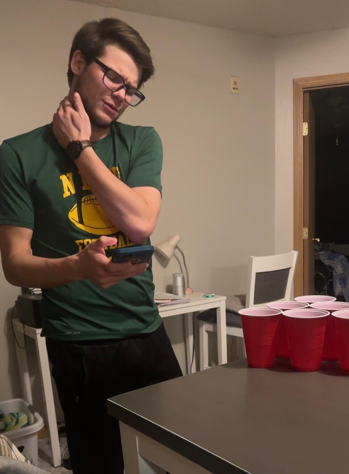 Snapped this six days before we made it official. We'd been dating for about a month, and I thought he was the cutest beer pong player—I just had to take a sneaky pic. 