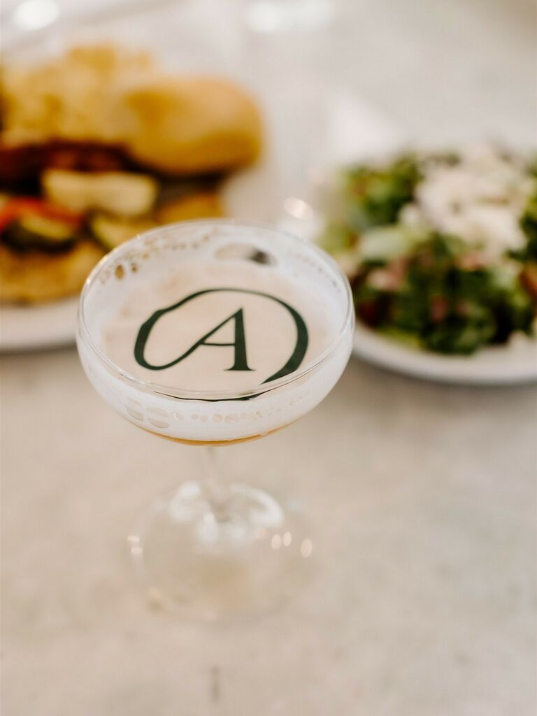 cocktail in coupe glass with monogrammed edible drink topper