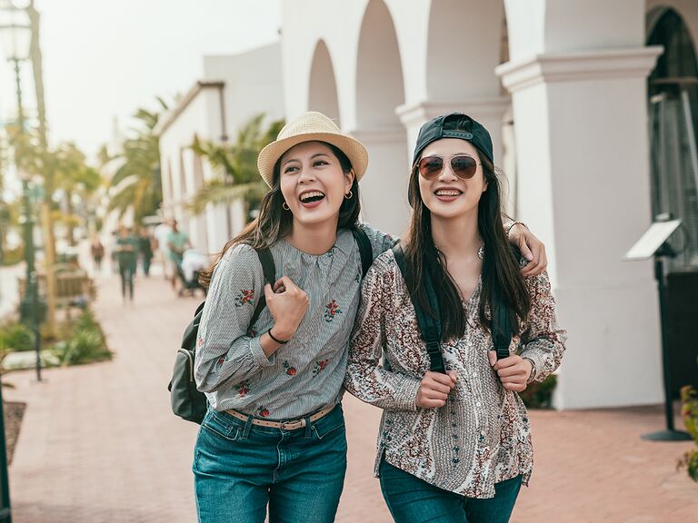 two young women walking down a street in santa barabara california