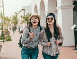 two young women walking down a street in santa barabara california