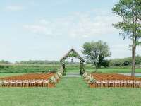 Outdoor wedding ceremony by covered bridge