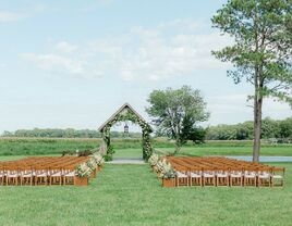 Outdoor wedding ceremony by covered bridge