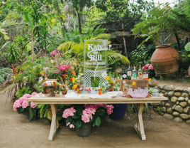 Katy and Bill engraved ice sculpture in a tropical reception background