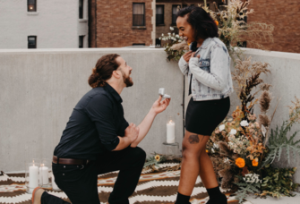 Man proposing to woman on rooftop 