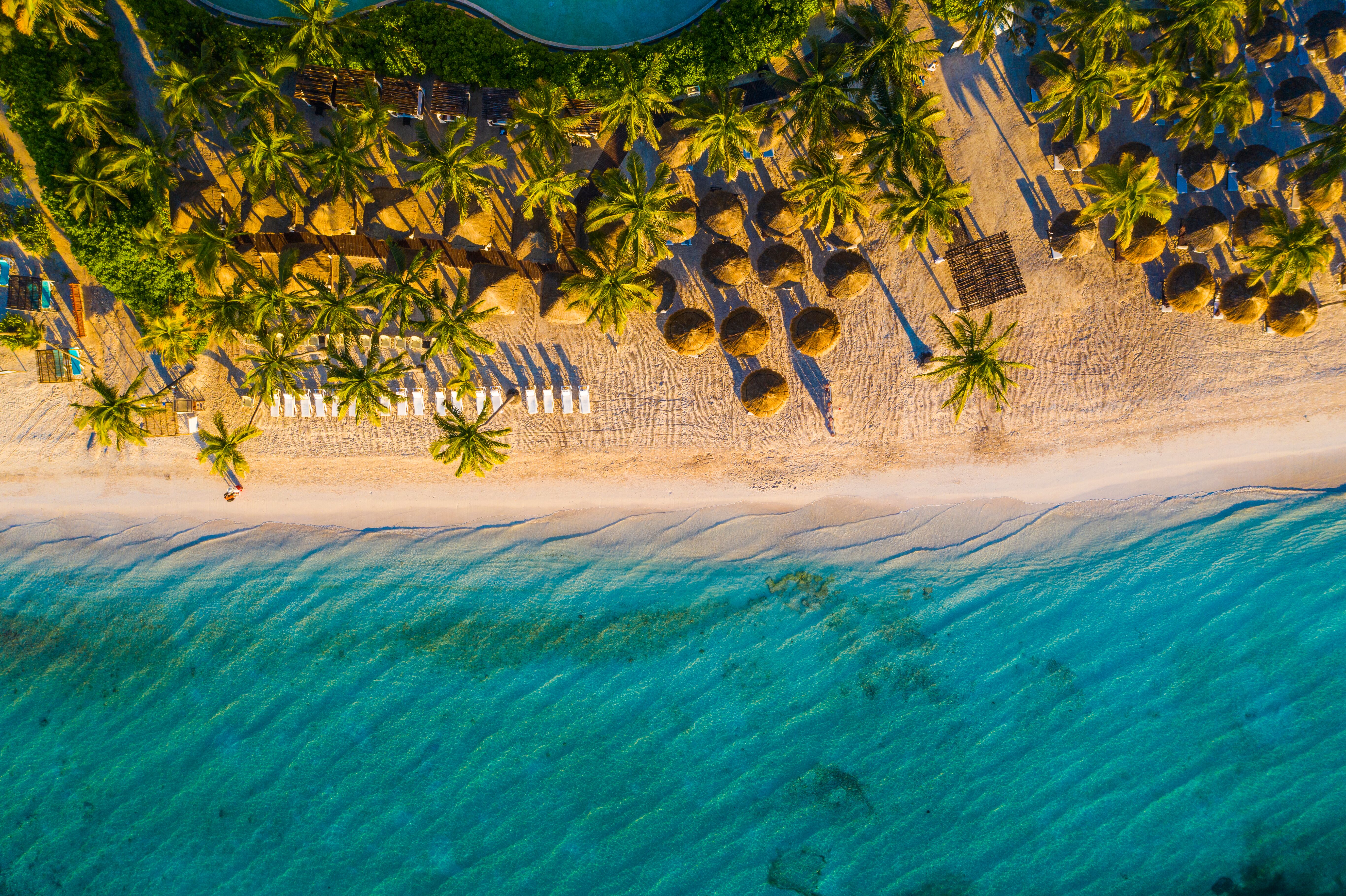 The sun peaks over the dunes at Playa del Carmen, Mexico.