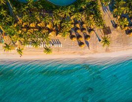 The sun peaks over the dunes at Playa del Carmen, Mexico.