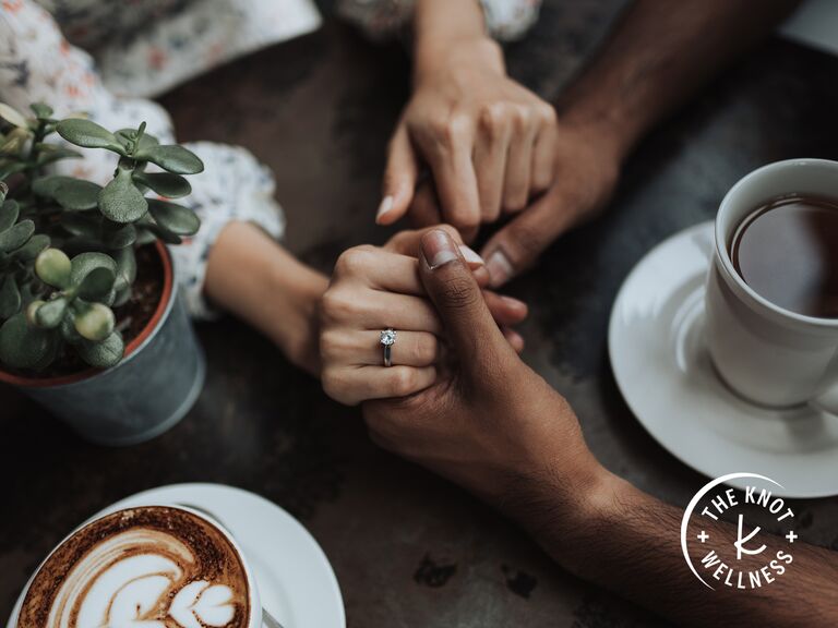couple holding hands at coffee shop discussing boundaries