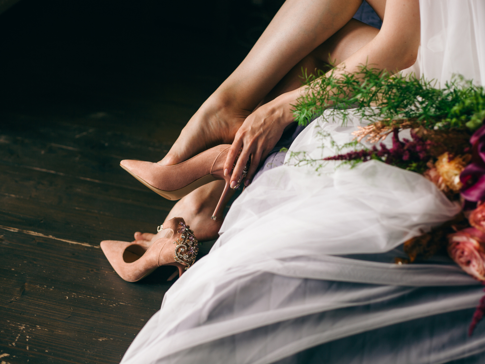 Bride putting on heels before the wedding