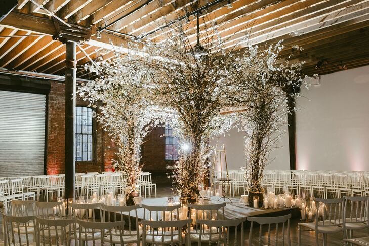 Chuppah decorated with flowering branches at industrial loft wedding ceremony