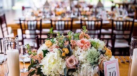 Elegant draping and dramatic lighting + florals for a surprise