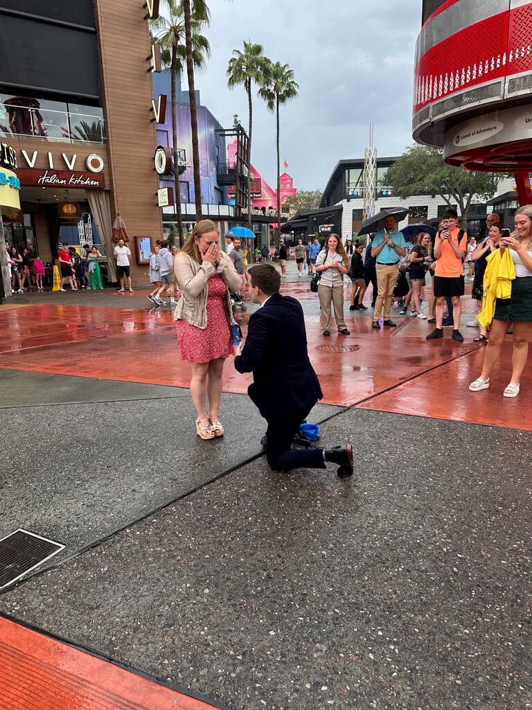 Kelly surprised Carlie by flying into town and coordinating with her friends to ask her to marry him at the very spot they first held hands.

"This is the spot where we first held hands, and I knew in that moment I never wanted to let it go." - Kelly