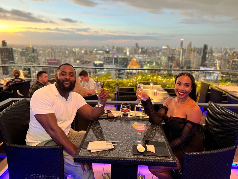The couple both share July birthdays and they spent their birthdays traveling the world together. They went to Dubai & Thailand. This photo was taken at a rooftop restaurant in Bangkok, Thailand. 