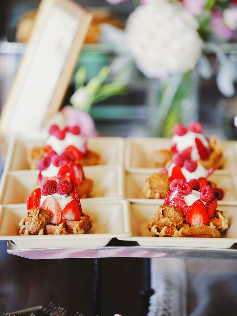 belgian waffles topped with whipped cream, strawberries and raspberries 