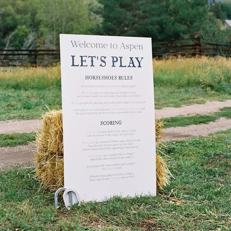 Western-Themed Sign on Bale of Hay at Rustic Rehearsal Dinner