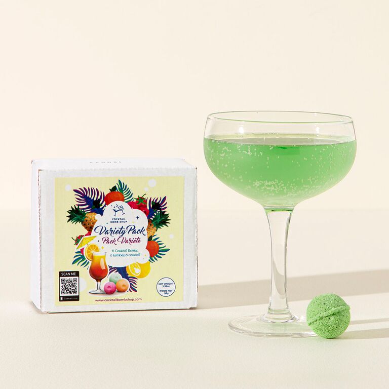 Cocktail bombs gift box pictured beside green drink