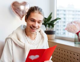 person reading valentine's day card