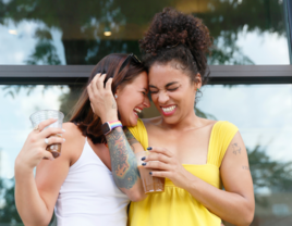 Women on coffee date hugging eachother