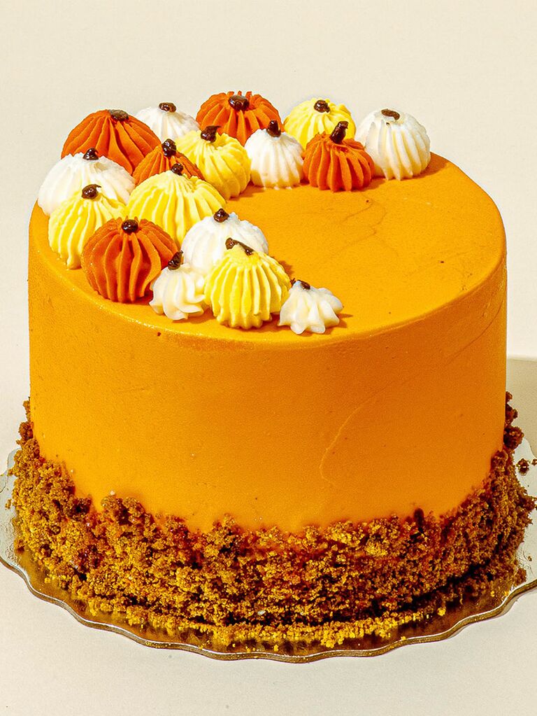Pumpkin spice cake with orange frosting and pumpkin icing toppings