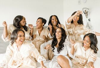 bridal party dancing in champagne bridesmaid robes