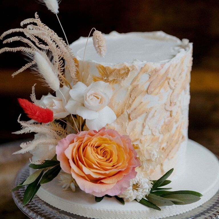 Textured beige wedding cake with flower decorations