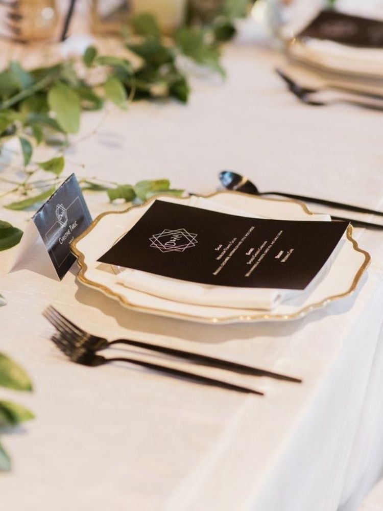 black-and-white place setting with gold accents
