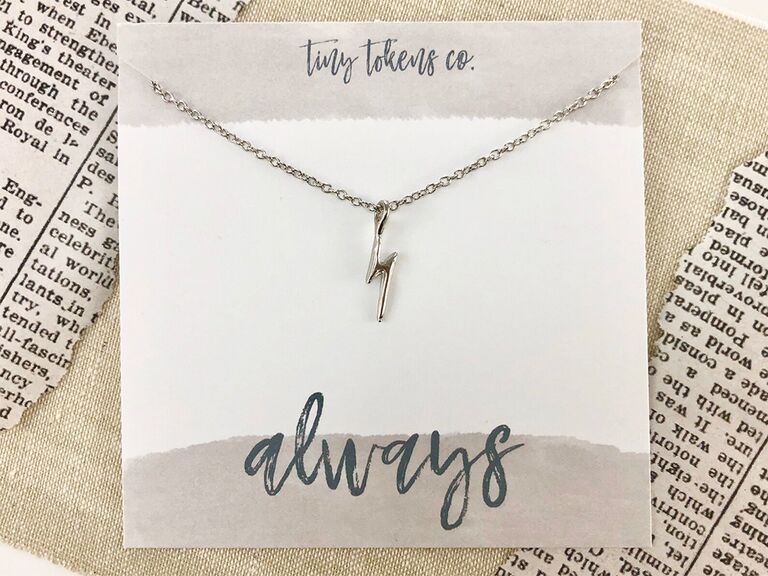 Silver lightening bolt necklace with 'always' in HP font on package