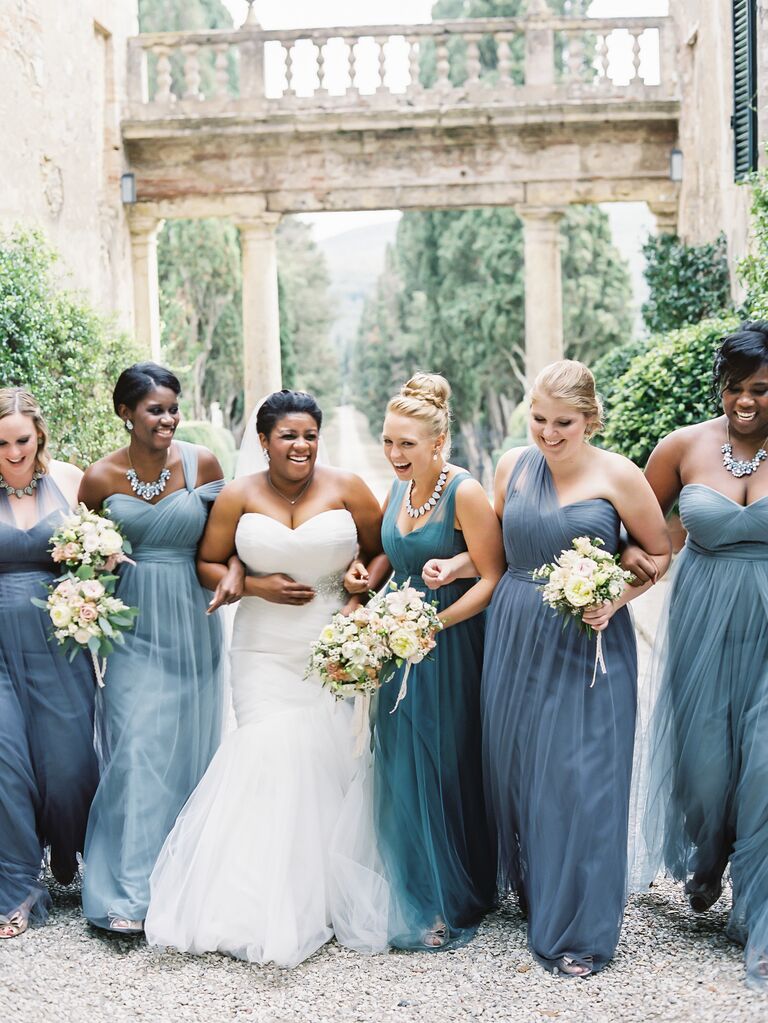Bridesmaids laughing with bride on wedding day