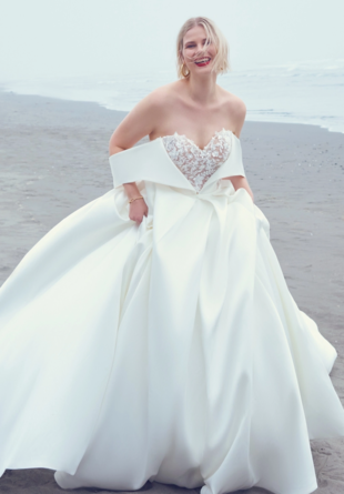 bride on beach wearing sweetheart strapless wedding dress with statement off-the-shoulder sleeves and lace bodice