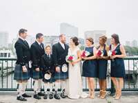 groomsmen in kilts for Irish wedding posing with wedding party