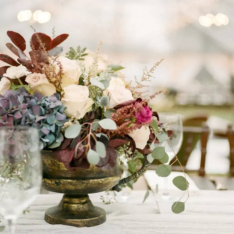 Flowers and Eucalyptus Filled Thrifted Vases and Served as Wedding Centerpieces