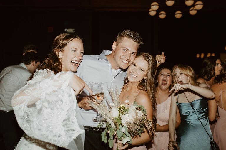 Paige catches the bouquet at one of her best friend's weddings.