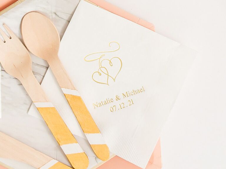 White napkin with names, date and heart illustration in gold