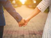 Couple holding hands on a street