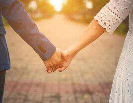 Couple holding hands on a street