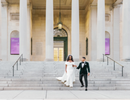 Bride and groom walking down steps of Baltimore Museum of Art wedding venue