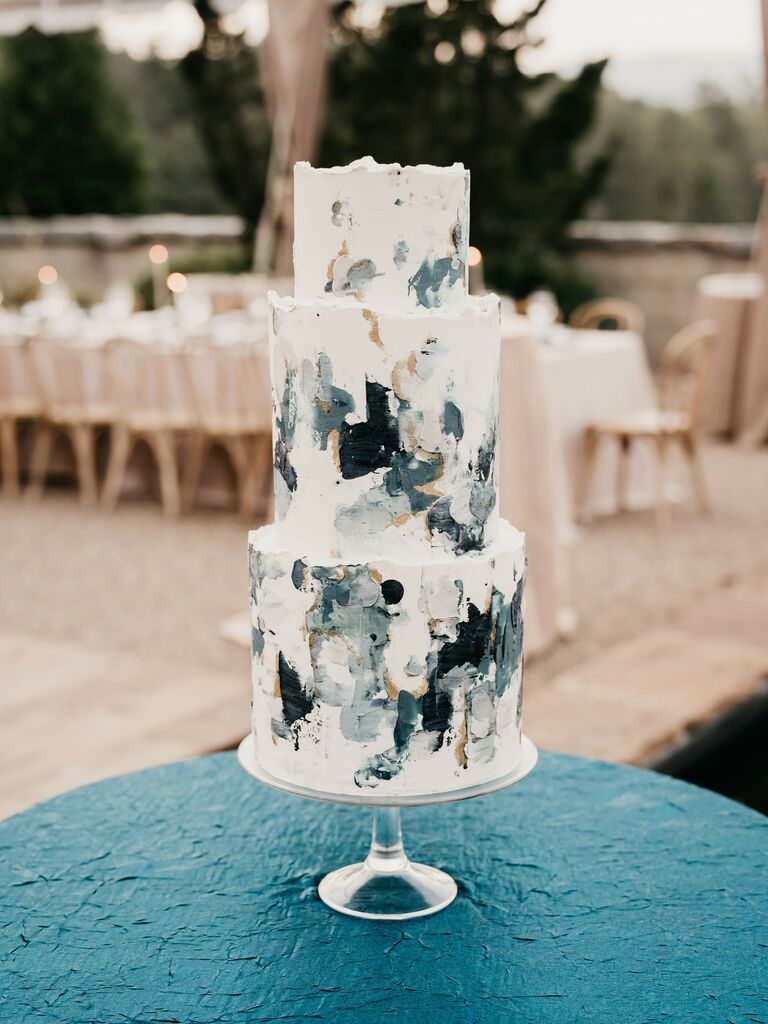 modern three tier wedding cake decorated with light and dark blue textured buttercream in abstract pattern