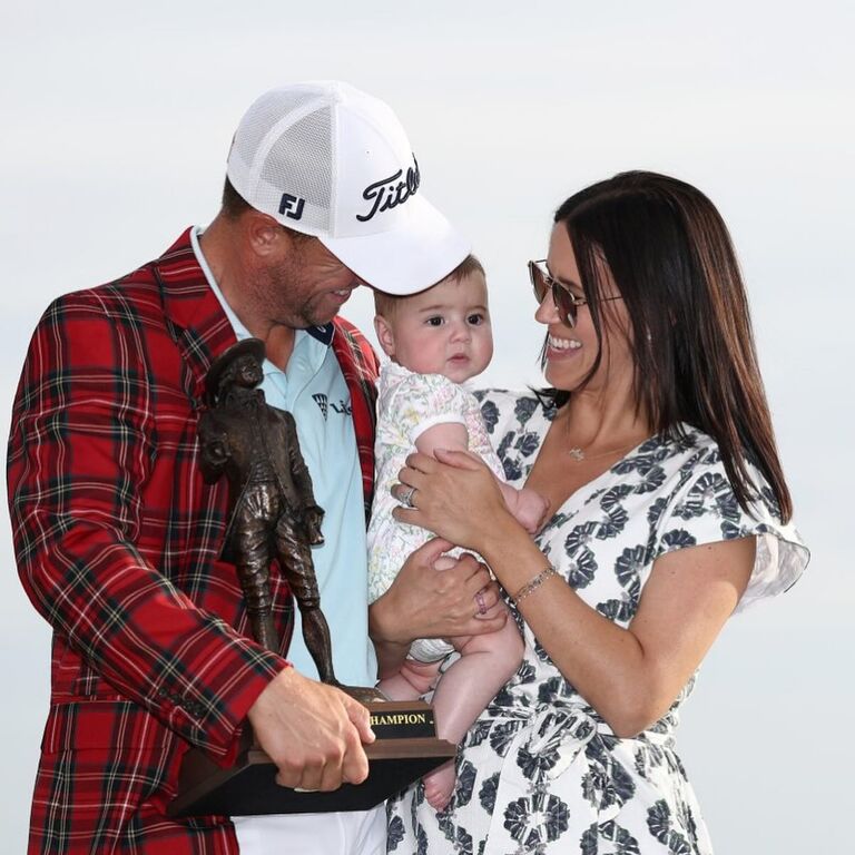 Justin Thomas and wife Jillian Wisniewski with their child