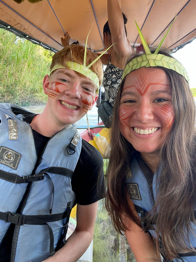 The first photo they took together! They were on a boat in the jungle and had just toured an indigenous tribe museum (hence the face paint).