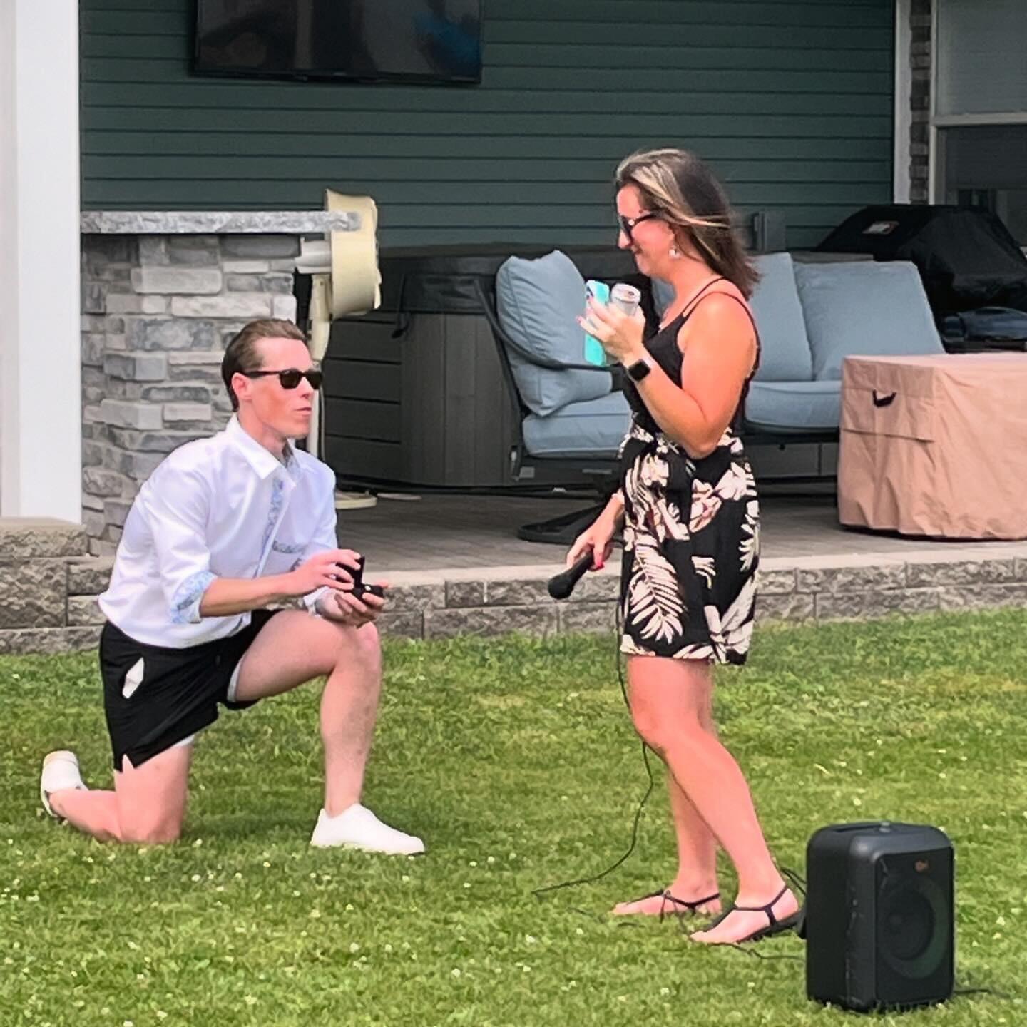 She says "Yes!" Derek proposes during their housewarming party in front of all their friends and family. 