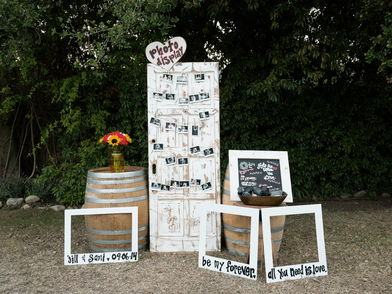 Wood photo booth, props, cameras as a wedding DIY decor project.