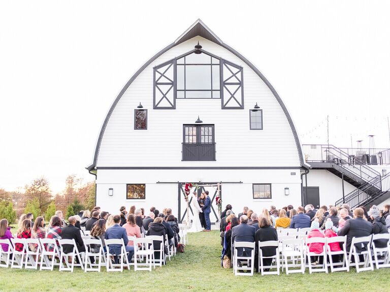 Ceremony outside the large white barn venue