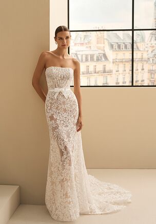 Two-piece mermaid silhouette wedding dress with sweetheart neckline. Removable long sleeves in lace with beading. Includes tulle overskirt with appliqués.