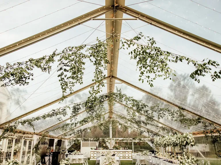 Clear wedding tent rental with greenery from Rentaland Tent & Event Rentals in Orlando, Florida